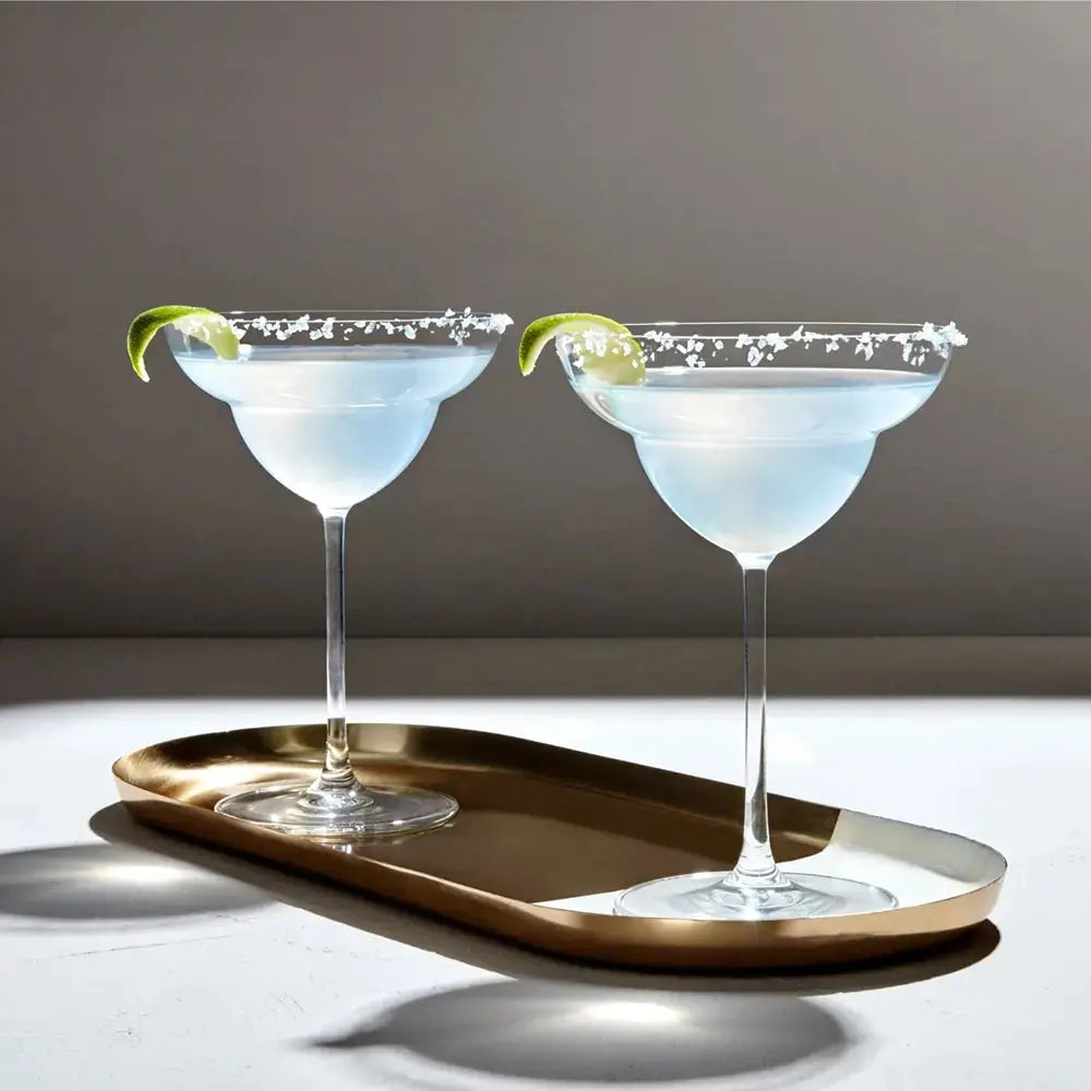 Set de deux verres à Margarita en cristal, disposés sur un plateau doré avec des cocktails garnis de sel et de citron vert. Idéal pour sublimer l’expérience de dégustation des cocktails apéritifs.